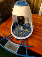 Hixx Smart Bird Feeder Camera & Seed Guard in light blue on a wooden table, featuring 2.5K HD camera, seed tray, and squirrel-proof design.